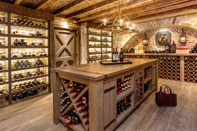 Inspiration for a large country wine cellar in Baltimore with medium hardwood floors and display racks.