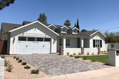 Inspiration for a farmhouse white one-story board and batten exterior home remodel in Phoenix with a black roof