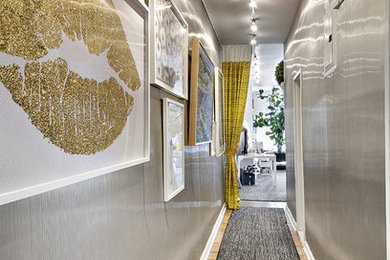 Hallway - small contemporary carpeted hallway idea in New York with gray walls