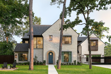 Transitional beige two-story exterior home photo in Houston with a shingle roof and a gray roof