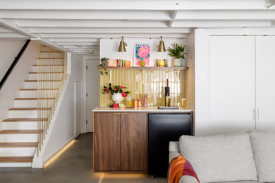 Example of a trendy concrete floor and gray floor dry bar design with flat-panel cabinets, dark wood cabinets, green backsplash and subway tile backsplash