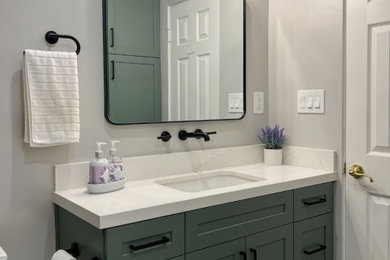 Bathroom - mid-sized transitional white tile and ceramic tile ceramic tile, white floor and single-sink bathroom idea in San Diego with shaker cabinets, green cabinets, a one-piece toilet, gray walls, an undermount sink, quartz countertops, white countertops and a built-in vanity