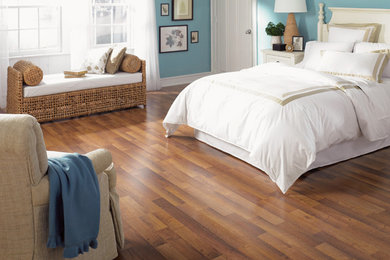 Large beach style master laminate floor and brown floor bedroom photo in San Diego with blue walls and no fireplace