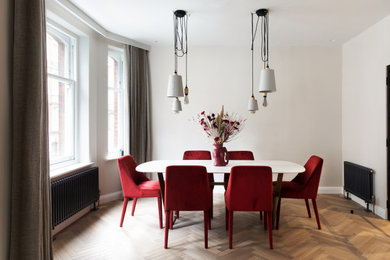 Inspiration for a medium sized contemporary enclosed dining room in London with grey walls, medium hardwood flooring, no fireplace and brown floors.