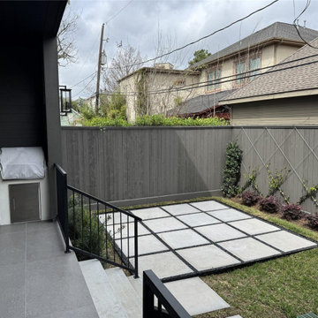 Modern landscaped backyard with paver path and privacy fencing