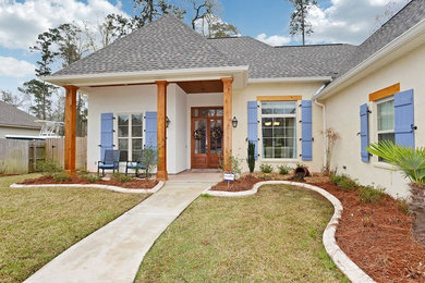 Elegant beige one-story stucco exterior home photo in New Orleans