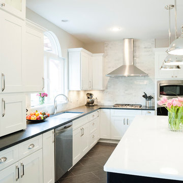 Transitional U-shaped kitchen with large island and angled wood flooring