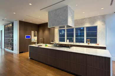 Kitchen - large contemporary medium tone wood floor kitchen idea in New York with an undermount sink, quartzite countertops, white backsplash, paneled appliances, an island and white countertops