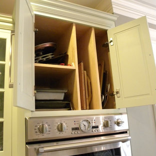 This is an example of a large transitional eat-in kitchen in Other with a farmhouse sink, shaker cabinets, green cabinets, recycled glass benchtops, ceramic splashback, stainless steel appliances and with island.