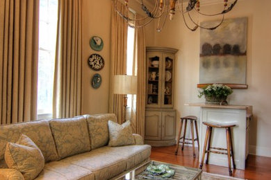 Living room - small traditional enclosed medium tone wood floor and brown floor living room idea in New Orleans with no fireplace and a wall-mounted tv