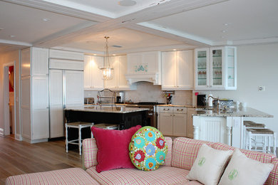 Open concept kitchen - huge coastal l-shaped light wood floor open concept kitchen idea in Tampa with an undermount sink, shaker cabinets, white cabinets, granite countertops, white backsplash, glass tile backsplash, stainless steel appliances and two islands