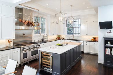 Design ideas for a large transitional eat-in kitchen in Los Angeles with an undermount sink, recessed-panel cabinets, white cabinets, white splashback, stone tile splashback, stainless steel appliances, dark hardwood floors, with island and granite benchtops.