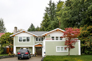 Large arts and crafts green two-story concrete fiberboard exterior home photo in Vancouver with a shingle roof