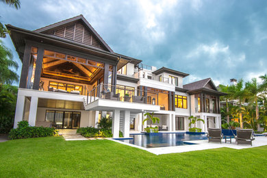 Inspiration for a huge transitional beige three-story stone gable roof remodel in Tampa
