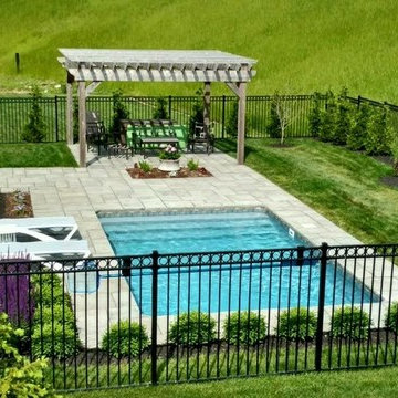Unilcok Rivenstone paver pool deck, Cedar pergola & Black Decorative aluminum fe