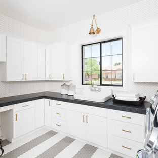 Photo of a mediterranean u-shaped separated utility room in Phoenix with shaker cabinets, white cabinets, white walls, a side by side washer and dryer, multi-coloured floors and grey worktops.