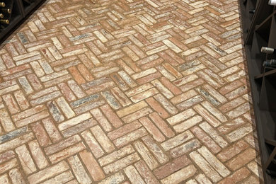 Urban brick floor wine cellar photo in Other