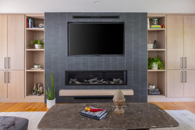 Example of a trendy open concept medium tone wood floor living room design in Boston with a ribbon fireplace, a tile fireplace and a media wall