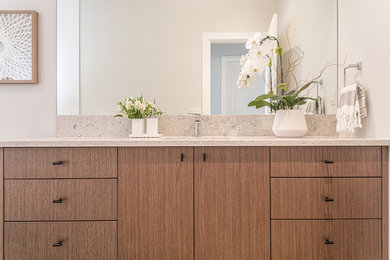 Bathroom - contemporary bathroom idea in Other with flat-panel cabinets, light wood cabinets and beige countertops