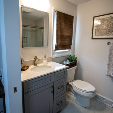 Gray Bathroom with Tiled Shower and Make-Up Area