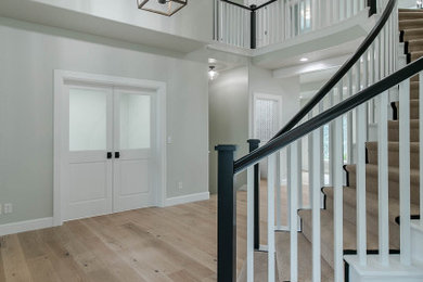 Foyer - large contemporary light wood floor and beige floor foyer idea in Portland with gray walls