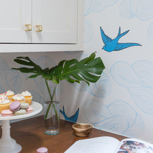 Modern kitchen pantry designs - Minimalist medium tone wood floor kitchen pantry photo in Albuquerque with a farmhouse sink, recessed-panel cabinets, white cabinets, wood countertops, white backsplash, stainless steel appliances and an island