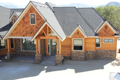 Rustic one-story stone exterior home idea in Other