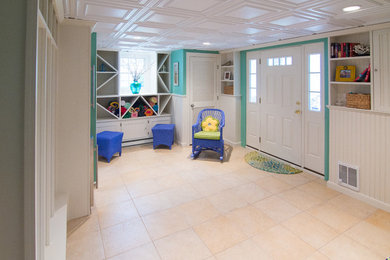 Example of a beach style walk-out ceramic tile basement design in Boston with green walls