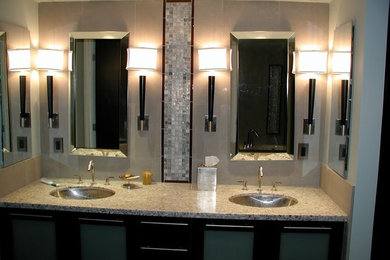 Example of a mid-sized trendy master beige tile and ceramic tile medium tone wood floor drop-in bathtub design in San Francisco with flat-panel cabinets, black cabinets, granite countertops, beige walls and an undermount sink