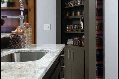 Inspiration for a large kitchen pantry in Los Angeles with a single-bowl sink, flat-panel cabinets, grey cabinets, granite benchtops, black splashback, stainless steel appliances, linoleum floors, brown floor and grey benchtop.