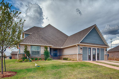 Inspiration for a modern blue two-story wood exterior home remodel in Oklahoma City