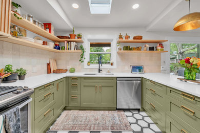 Eat-in kitchen - mid-sized transitional u-shaped ceramic tile and multicolored floor eat-in kitchen idea in Austin with an undermount sink, shaker cabinets, green cabinets, quartz countertops, beige backsplash, ceramic backsplash, stainless steel appliances and white countertops