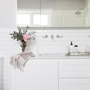 Photo of a transitional bathroom in Canberra - Queanbeyan with shaker cabinets, white cabinets, a freestanding tub, an open shower, a one-piece toilet, white tile, subway tile, grey walls, porcelain floors, a vessel sink, engineered quartz benchtops, an open shower, white benchtops, a double vanity and a floating vanity.