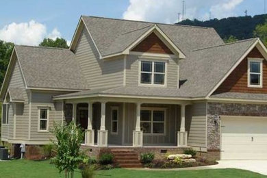 Example of a large arts and crafts beige two-story vinyl exterior home design in Other with a shingle roof