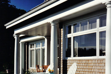 Mid-sized elegant concrete back porch photo in Other with a roof extension