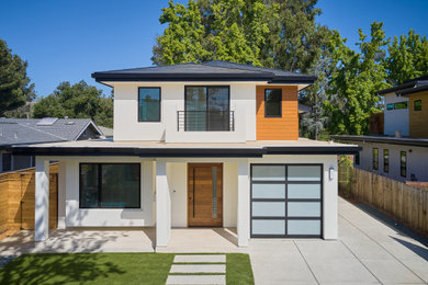 Example of a mid-sized minimalist white three-story stucco house exterior design in San Francisco with a hip roof, a mixed material roof and a gray roof