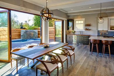 Transitional medium tone wood floor great room photo in Los Angeles with gray walls