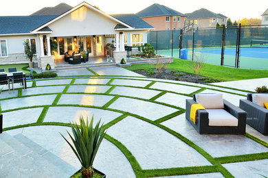 Inspiration for a large contemporary backyard concrete patio kitchen remodel in Toronto with a gazebo