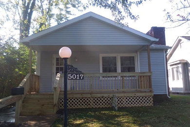 Inspiration for a mid-sized timeless front porch remodel in Indianapolis with decking and a roof extension