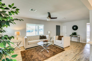 Living room - mid-sized transitional open concept medium tone wood floor living room idea with gray walls, a standard fireplace, a brick fireplace and a wall-mounted tv