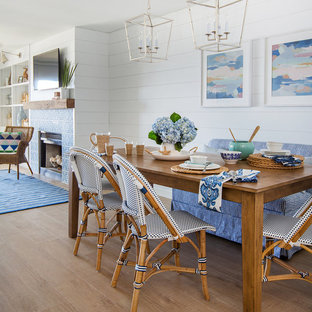 Great room - mid-sized beach style medium tone wood floor great room idea in Jacksonville with white walls, a standard fireplace and a tile fireplace