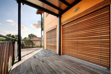 This is an example of a contemporary deck in Milan with a pergola.