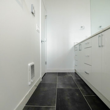 White Vanity and Sink with Dark Accent Flooring