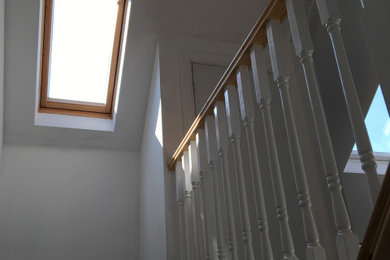 Photo of a traditional hallway in Devon with white walls, carpet and grey floor.