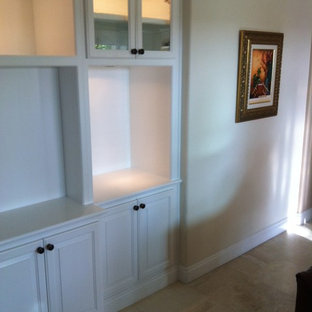 Large traditional open plan home cinema in Orange County with beige walls, travertine flooring and a built-in media unit.
