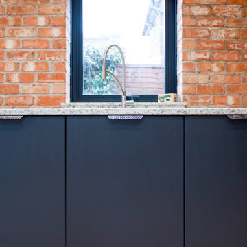 Industrial Kitchen With Exposed Brick & Stainless Steel Features