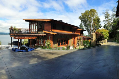 Huge contemporary brown two-story wood exterior home idea in Seattle