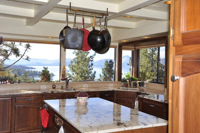 Example of a mid-sized transitional u-shaped enclosed kitchen design in Other with an undermount sink, shaker cabinets, dark wood cabinets, granite countertops, beige backsplash, porcelain backsplash, stainless steel appliances and an island