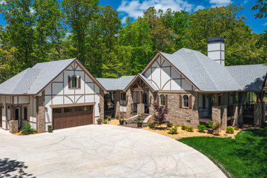 Inspiration for a large craftsman beige one-story brick exterior home remodel in Atlanta with a tile roof and a brown roof