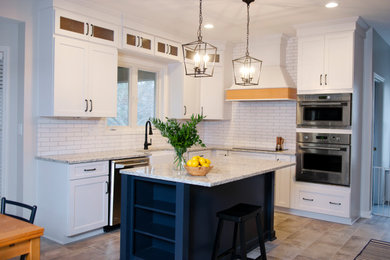 Inspiration for a mid-sized cottage l-shaped ceramic tile and beige floor eat-in kitchen remodel in Louisville with a farmhouse sink, shaker cabinets, white cabinets, granite countertops, white backsplash, ceramic backsplash, stainless steel appliances, an island and white countertops